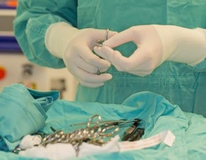 Surgeon organizing sterile instruments