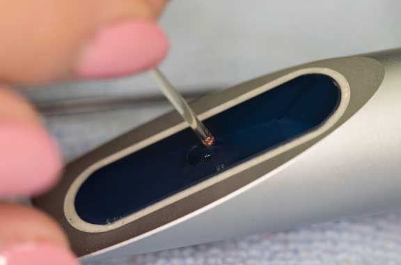Serum being put on a refractometer.
