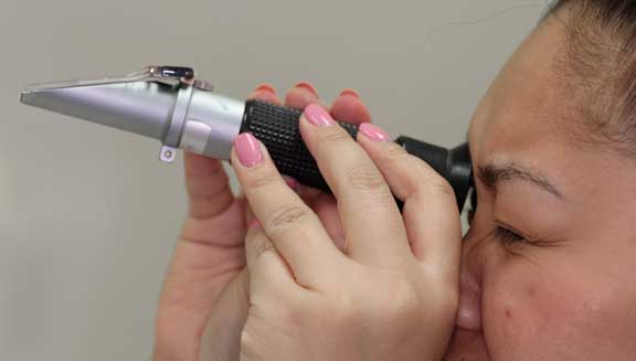 Reading a refractometer.