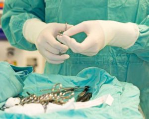 Surgeon preparing instruments for surgery