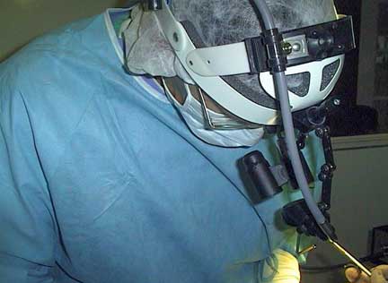 Surgeon using magnifying glasses