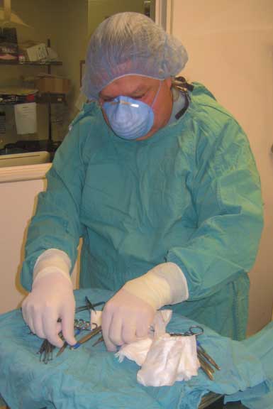 Surgeon preparing sterile instruments