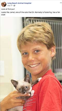 Jamal the kitten being held by a boy.