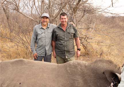 Two veterinarians (Dr. P and Andre Uys) with a sedated rhinoceros