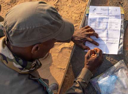 Park ranger signing rhino DNA form